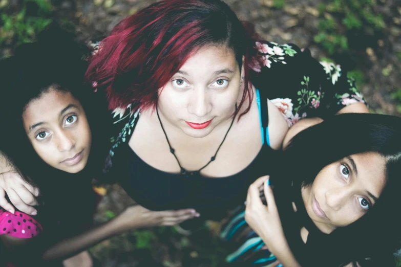 three girls standing around each other and posing for a po