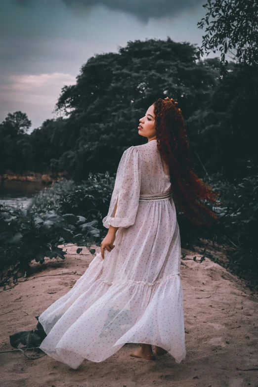 a woman with long red hair wearing a white dress