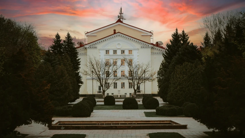 a white church with a red and blue sky