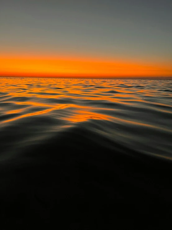 a view from the water in front of a sunrise