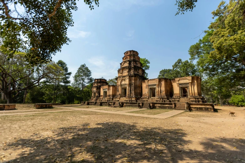 a group of structures with trees in the background