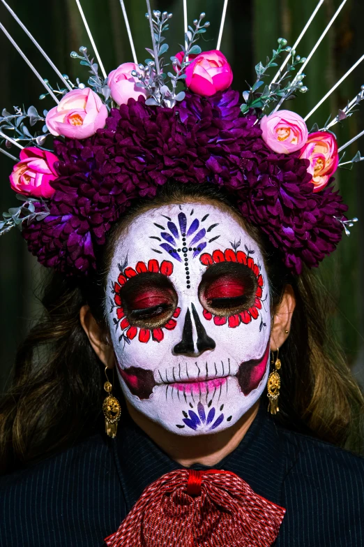 woman with painted face wearing red and pink flowers