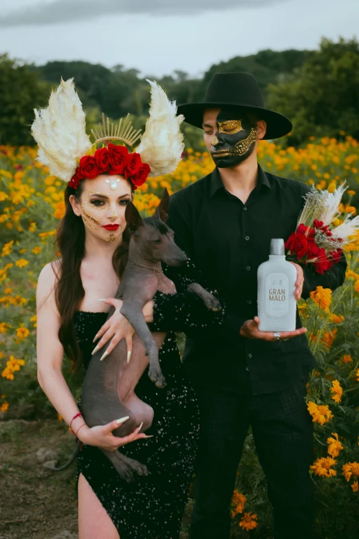 a couple posing for a po in the flowers