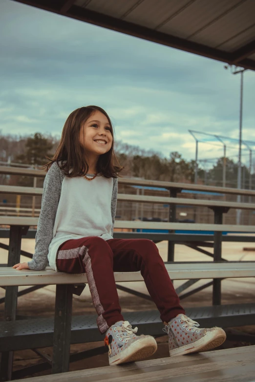 a  is smiling on a bench