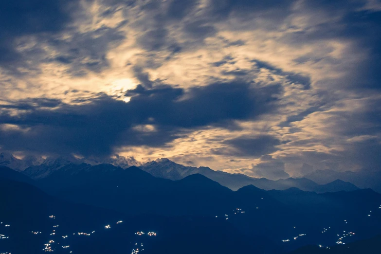 the clouds roll in on top of the mountains