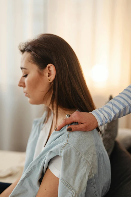 a woman getting her hair combed by a beauty professionals