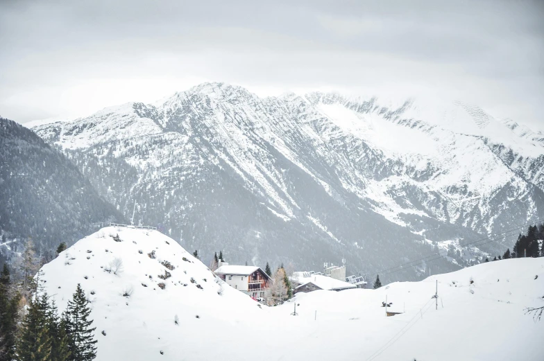 a house sitting on top of a snow covered hill