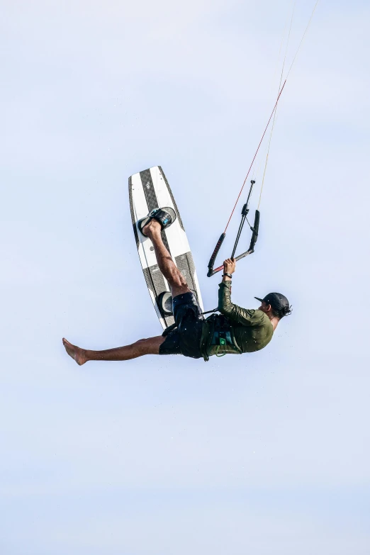 the man is trying to get up after having fallen from his wake board