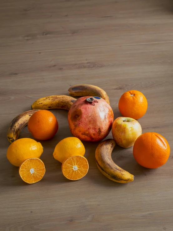 a pile of different fruits with some bananas and oranges