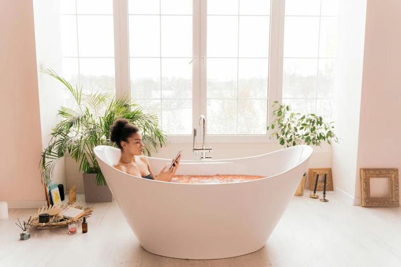 a woman laying in an old bath tub in a room