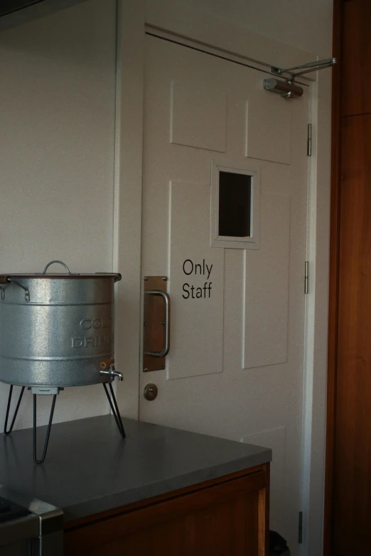 an old fashioned kitchen with an only staff sign