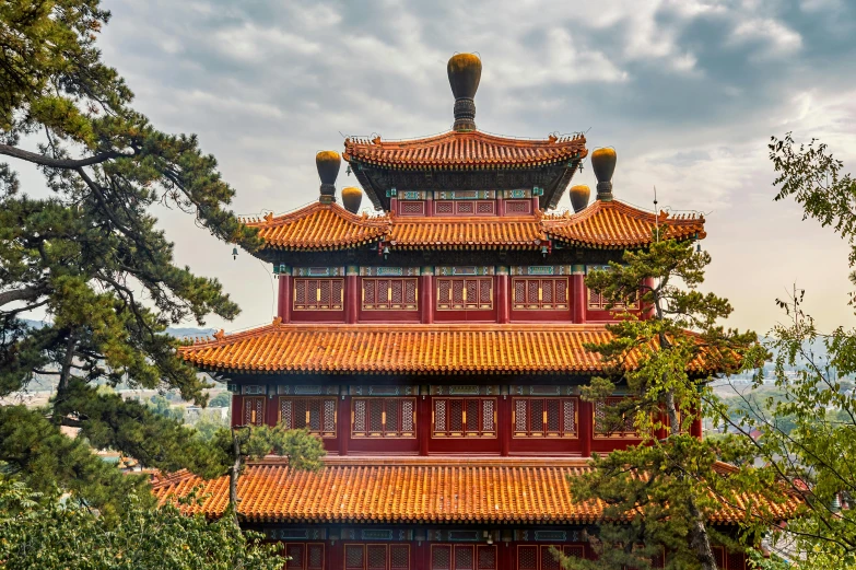 red chinese building with trees surrounding it