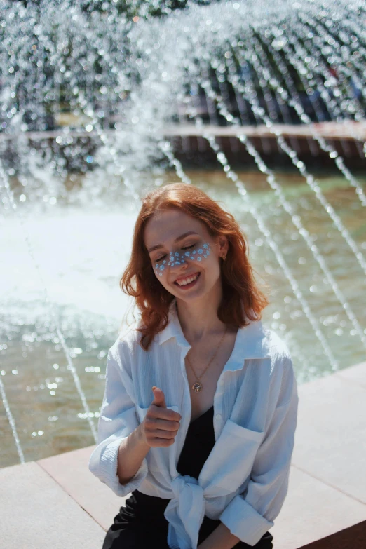 a pretty red headed girl wearing blue glasses