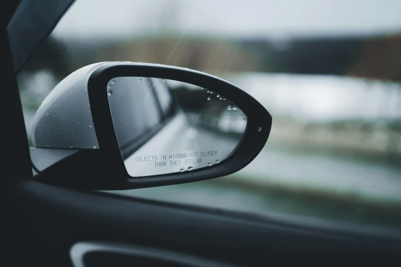 a side mirror showing cars view in the side view mirror