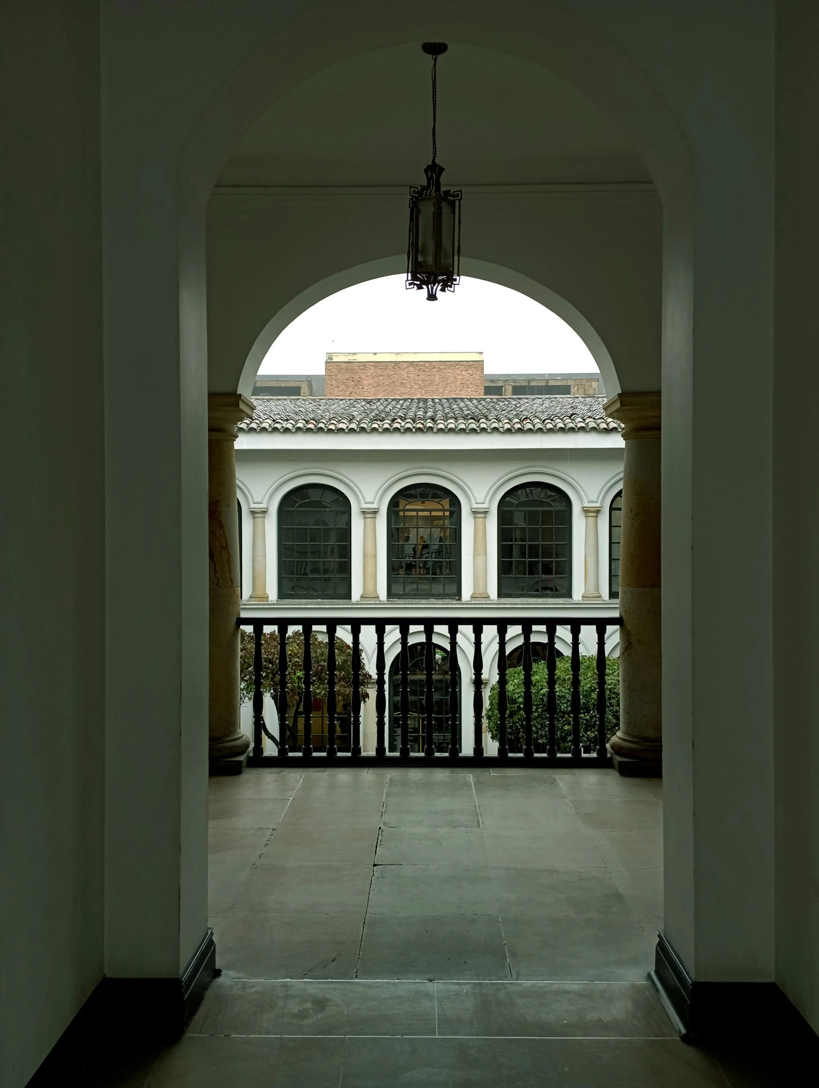 an archway leading into the entrance to an apartment building