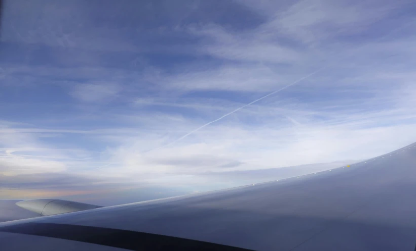 the view of an airplane wing while it flies