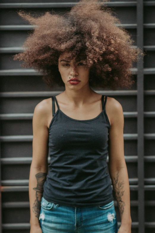 an image of a woman with dreadlocks looking at the camera