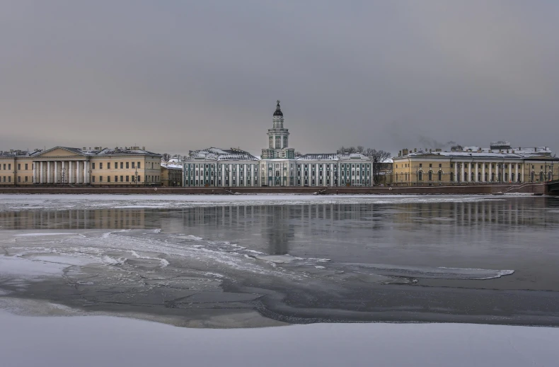 a large building in the middle of a big frozen lake