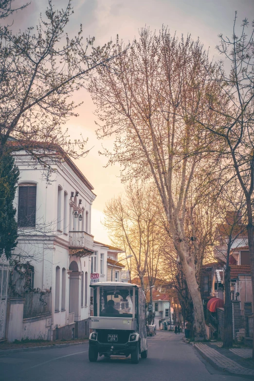 an old - fashioned truck drives down the street in town