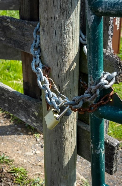 a metal chain links on a wooden fence