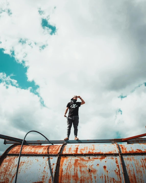 a person standing on the top of a metal pipe