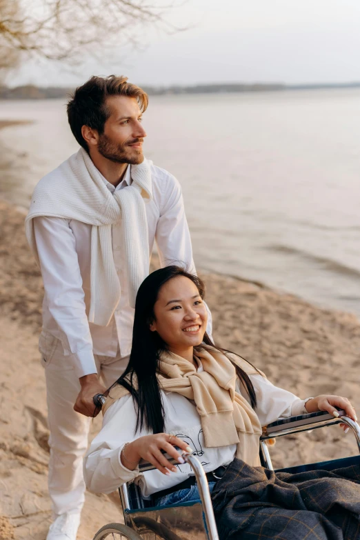 an image of a woman hing a man in a wheelchair