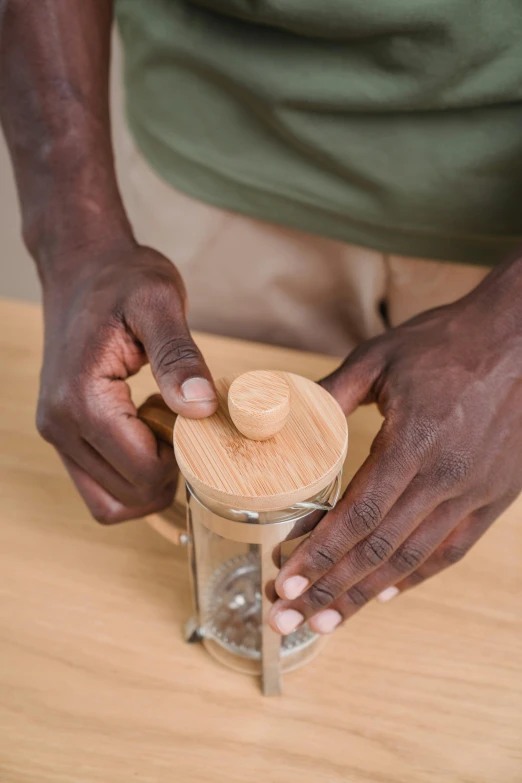 a man is putting sand in a container that has been sanded