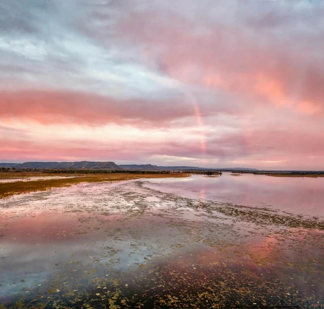 the sky is reflecting off of a calm lake