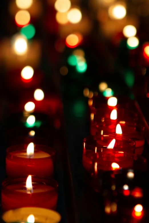 candles are on display in red and green lites