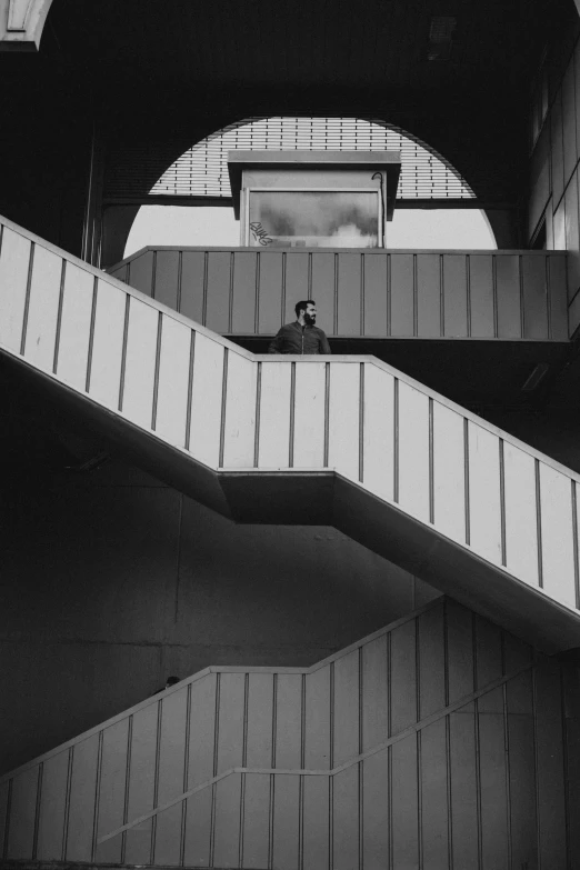 a black and white po of a man on the stairs