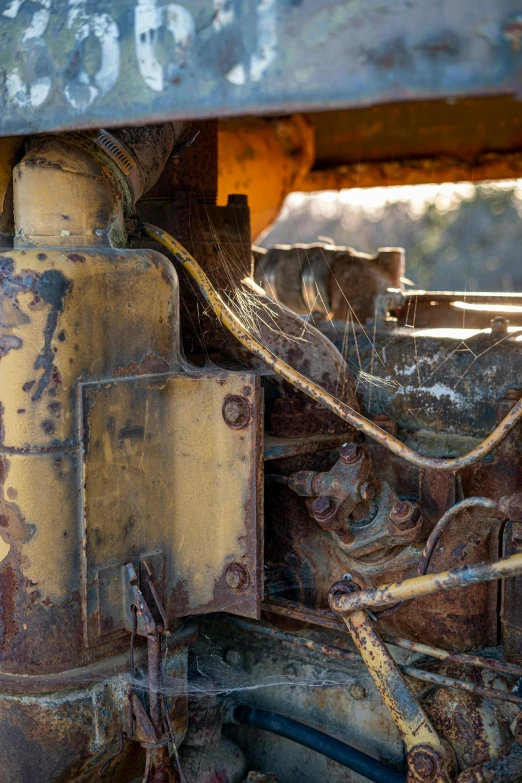 an old rusted truck with many wires attached