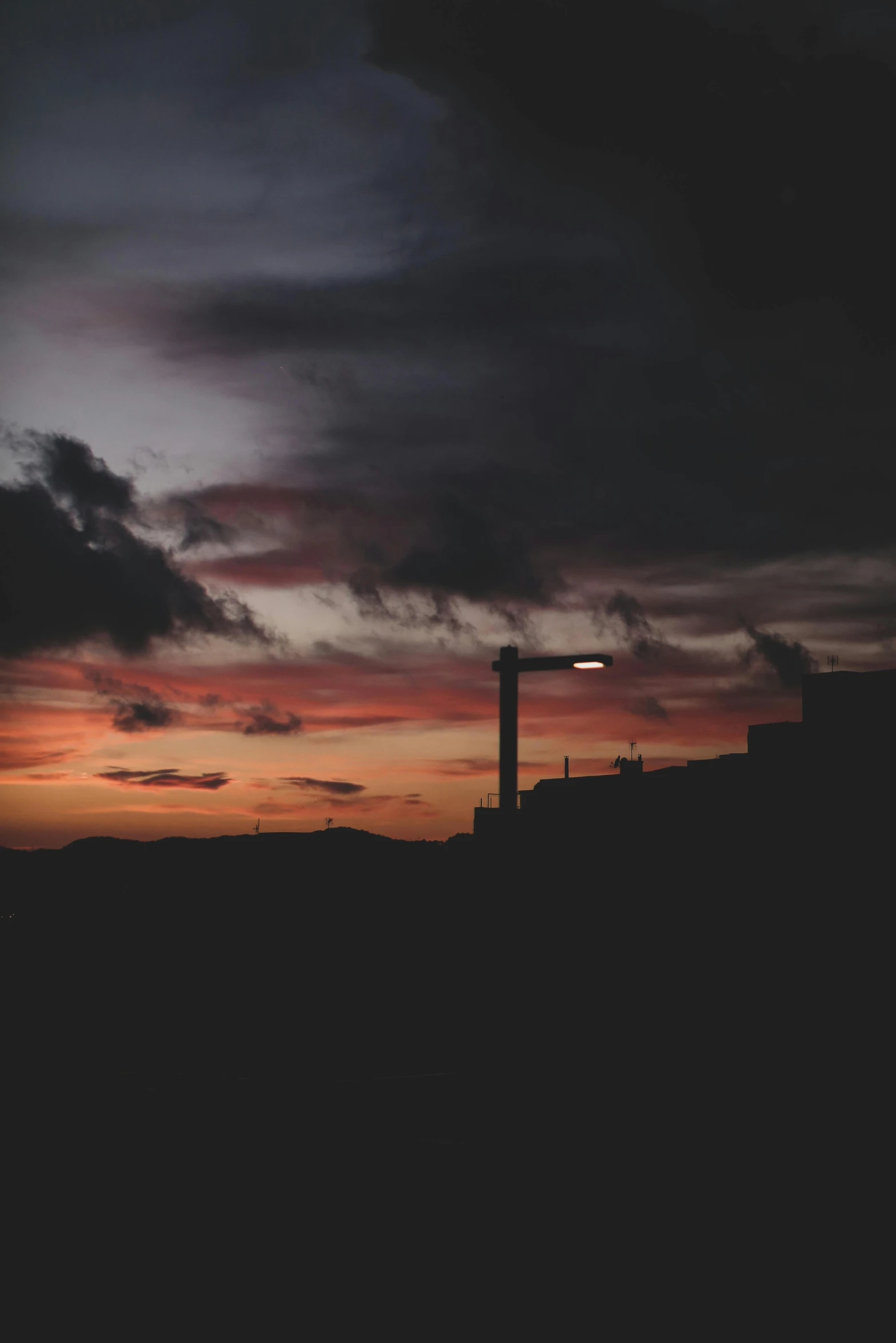 a building in the distance with the sky lit up at night