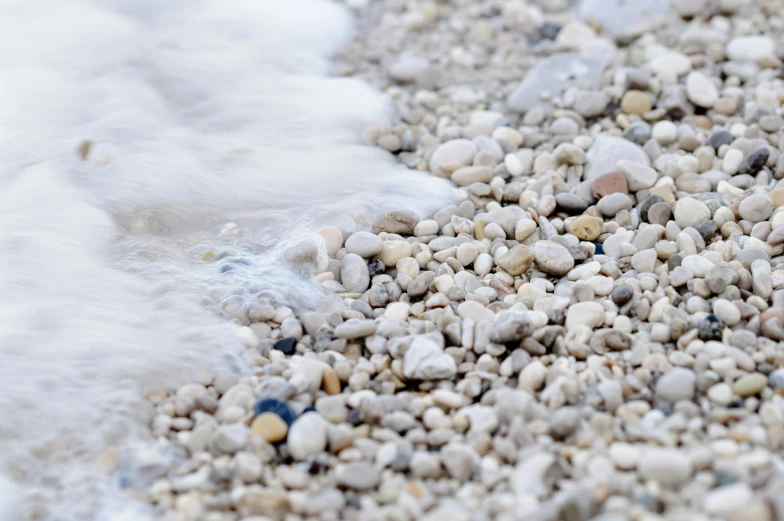 small rocks in front of water and white substance