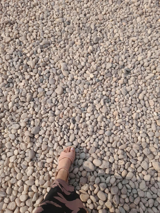 a persons legs on a rock surface