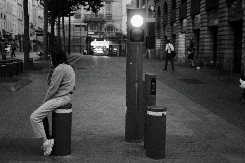 a black and white po of a person sitting on a box