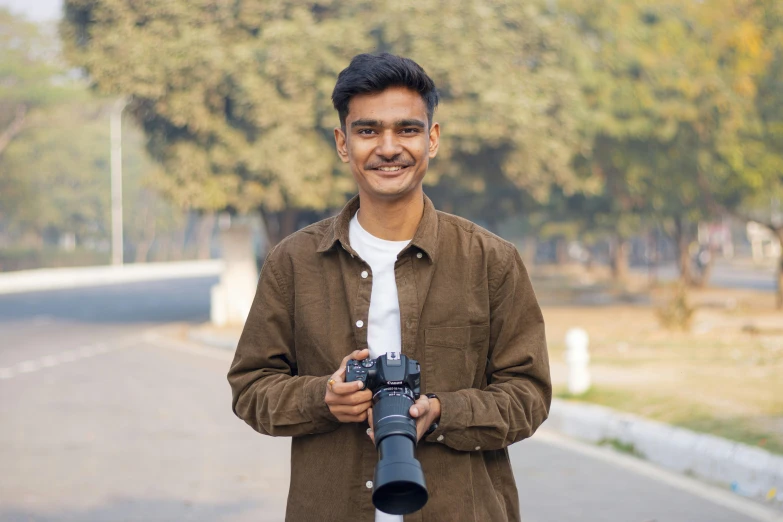 a man stands in the street with a camera