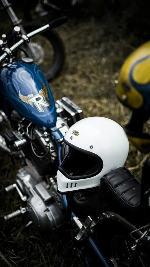 the front of a motorcycle and helmet, on some grass