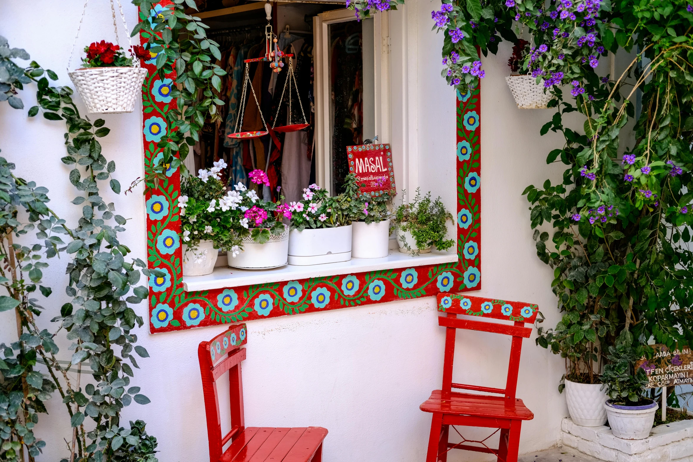 two red chairs sitting next to each other near a window