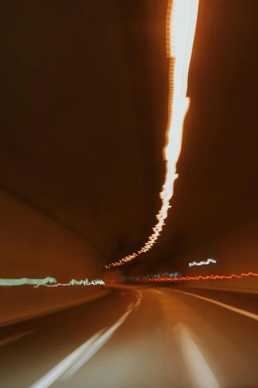 a car driving through a tunnel at night