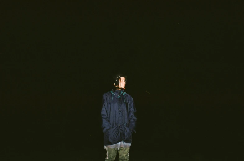 a man in a rain jacket standing on the ground