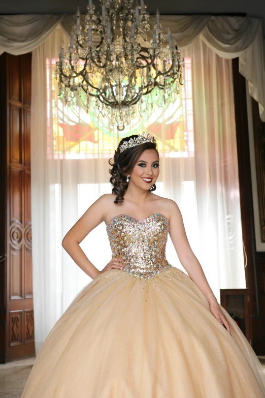 a pretty young woman wearing a champagne colored dress