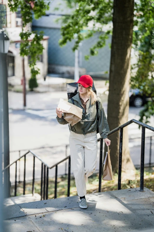 a woman in white pants is walking down stairs