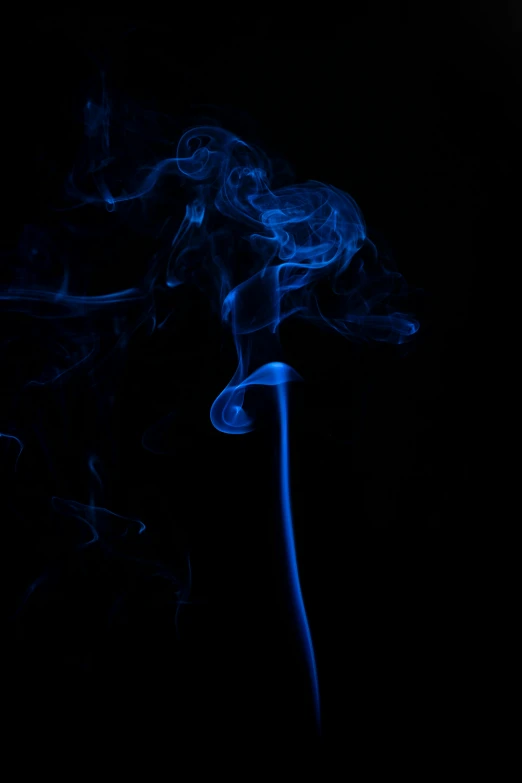 blue smoke rises from a black background