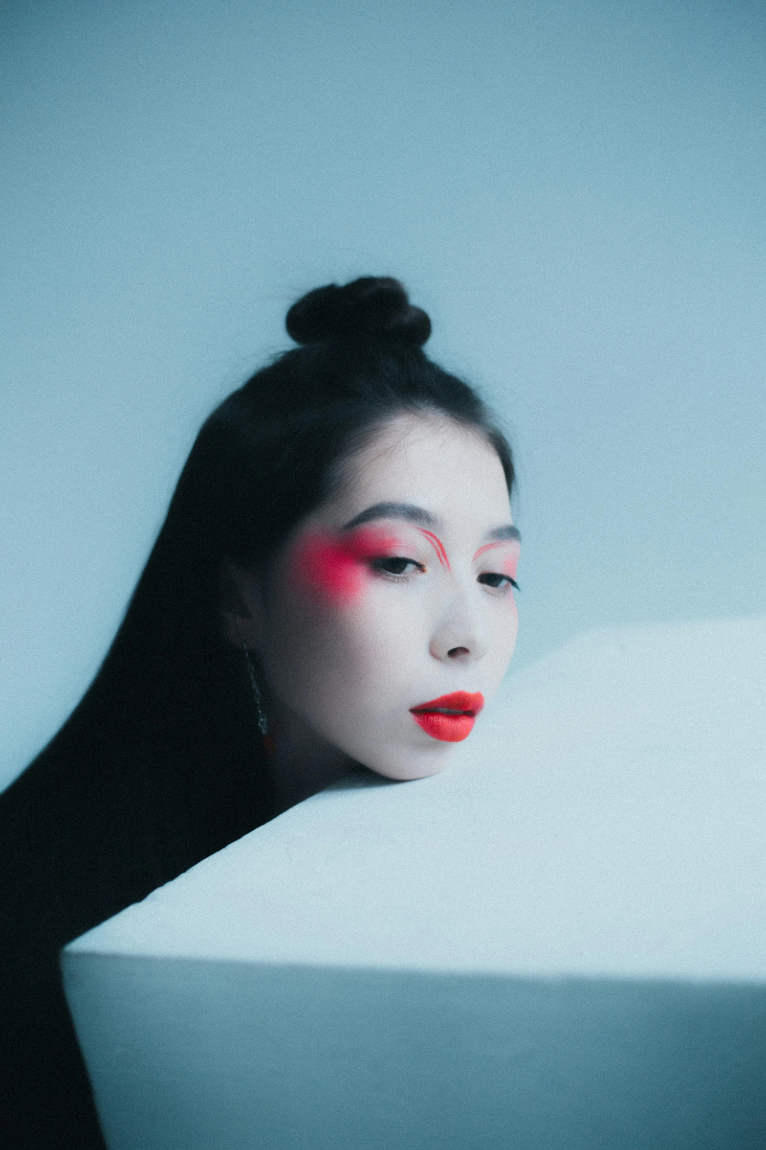 a woman wearing red eyeshade and an elegant hair style