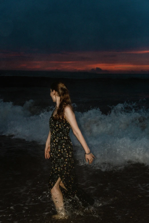 woman in the ocean in an unkempt dress