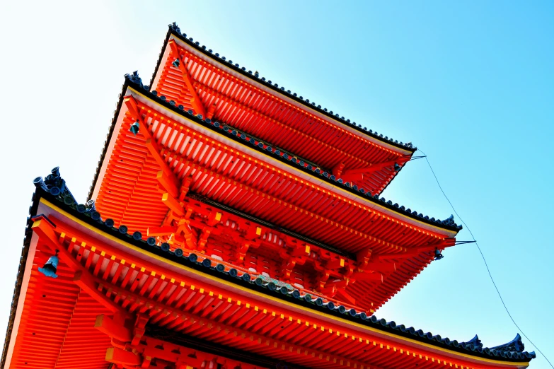 a tall building has four red chimneys