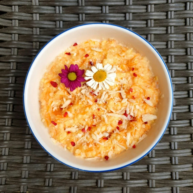 the bowl has white rice and various flowers in it