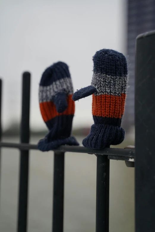 an image of stuffed things sitting on top of a fence