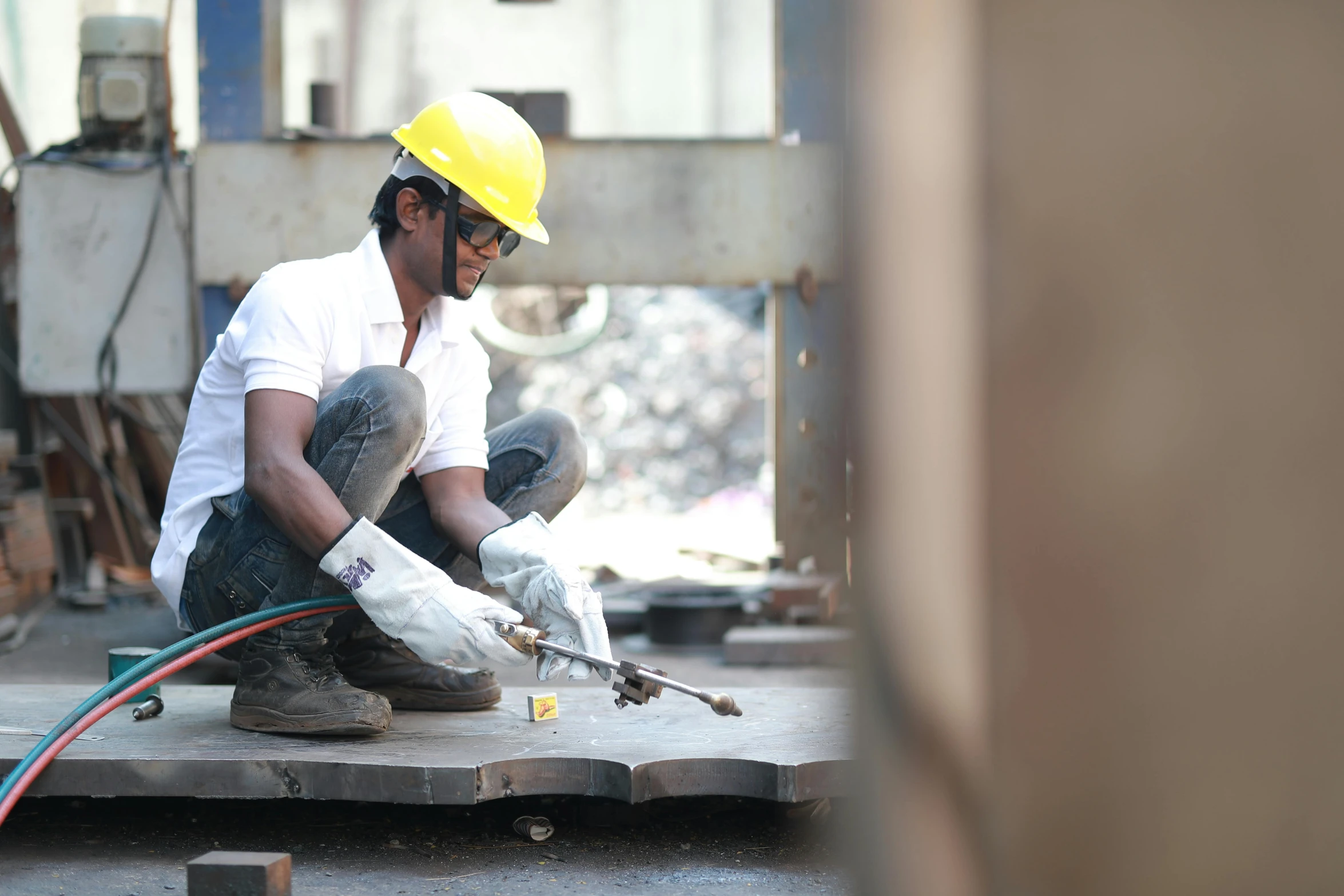 there is a man in a helmet working with concrete