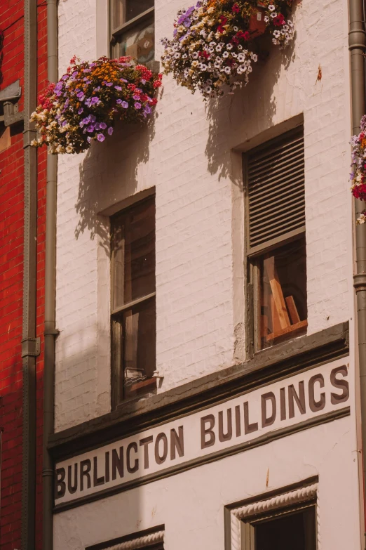 a building that has three flower hanging from the top